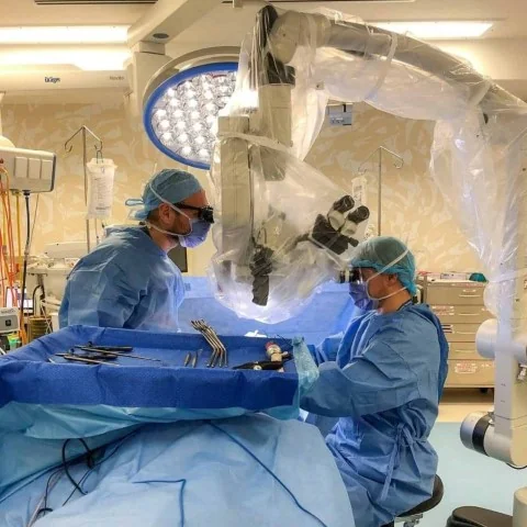 Sterile surgical steel instruments neatly arranged on a clinical tray, reflecting active neurosurgical practice.
